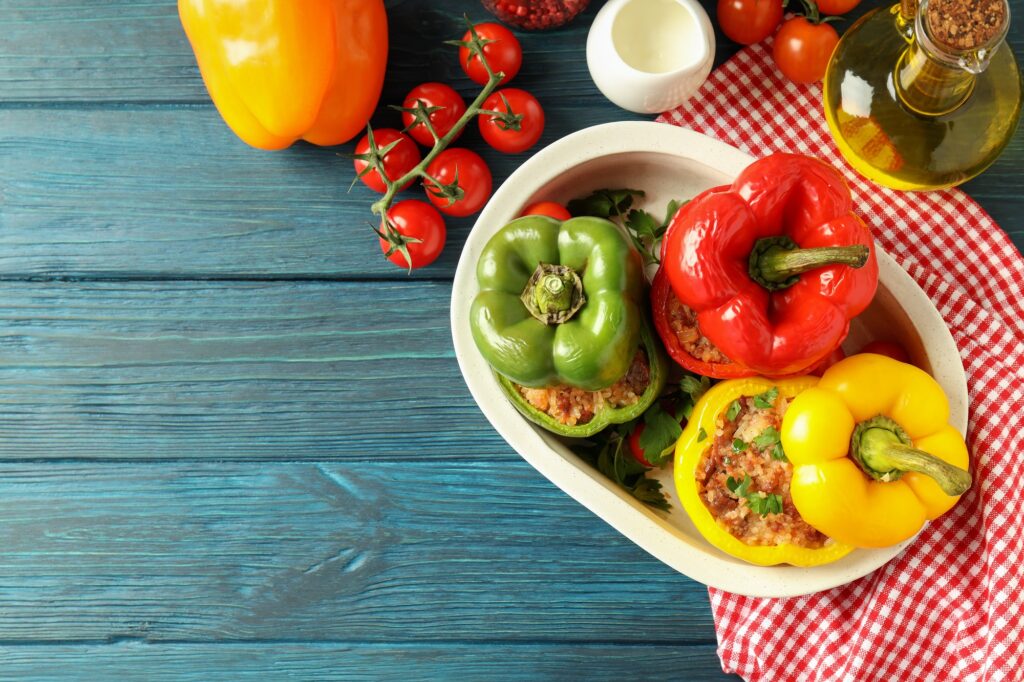 Concept of tasty food with ​stuffed pepper on wooden background